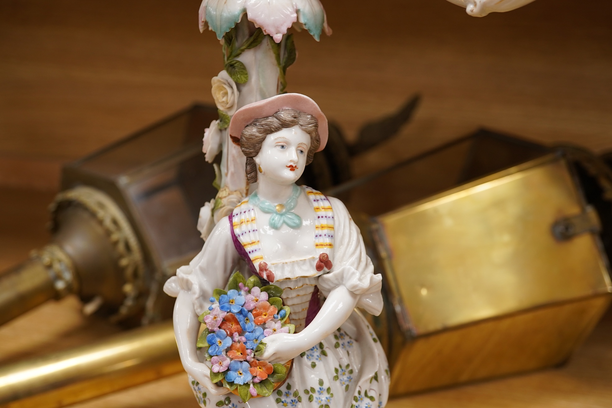 A pair of Volkstedt porcelain figural three branch candelabra with floral encrusted decoration, 51cm high